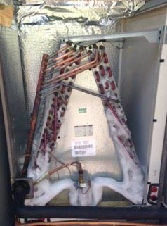 An AC evaporator coil with ice built up on it